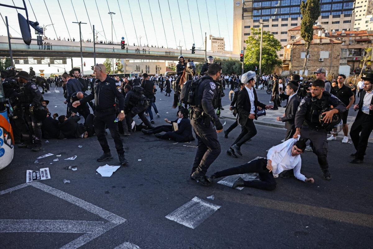 Israeli police disperse ultra-Orthodox Jews protesting against conscription by blocking the entrance to Jerusalem, on June 1, 2026. (Ahmad Gharabli/AFP via Getty Images)
