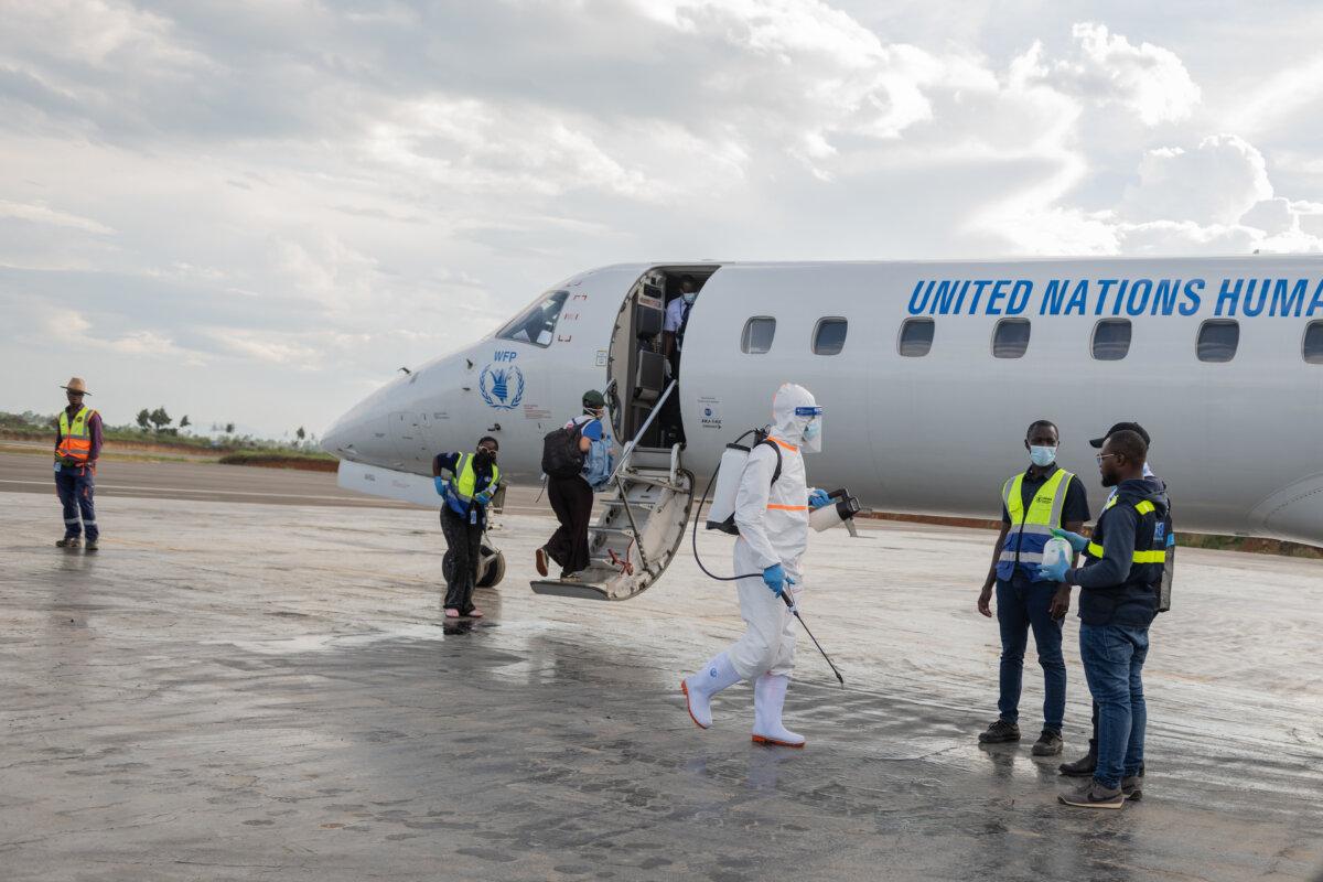A health worker disinfects the airport near the World Food Programme's aircraft in Bunia, Congo, on June 2, 2026. (Moses Sawasawa/AP Photo)