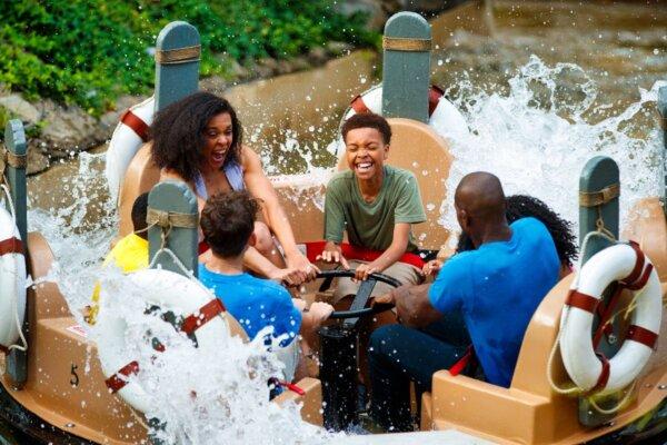 Guests cool off from the summer heat aboard the Smoky Mountain River Rampage, a whitewater rafting simulation that promises to leave everyone soaked. (Dollywood Parks & Resorts)
