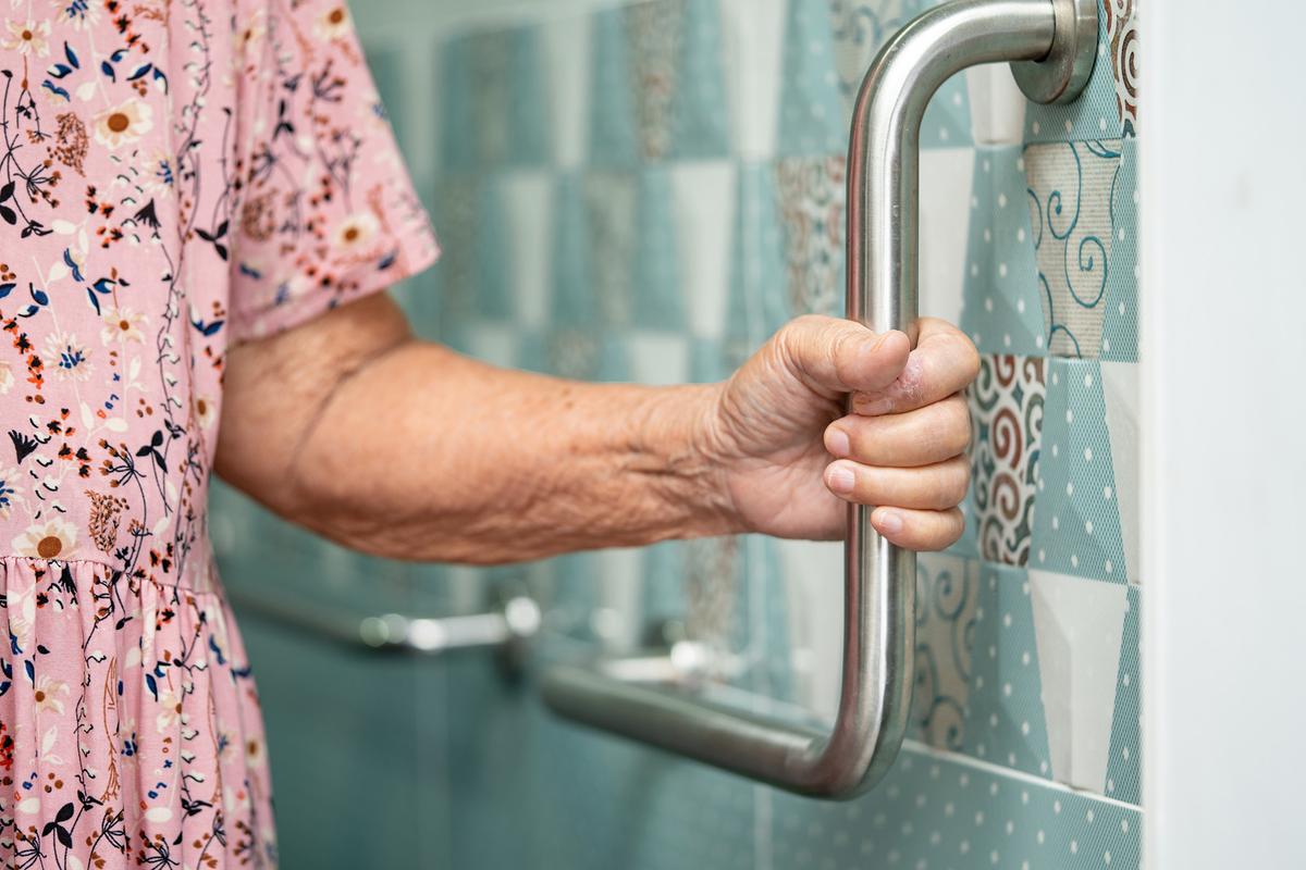 It's essential to properly anchor grab bars into wall studs so they can support weight. (sasirin pamai/Shutterstock)