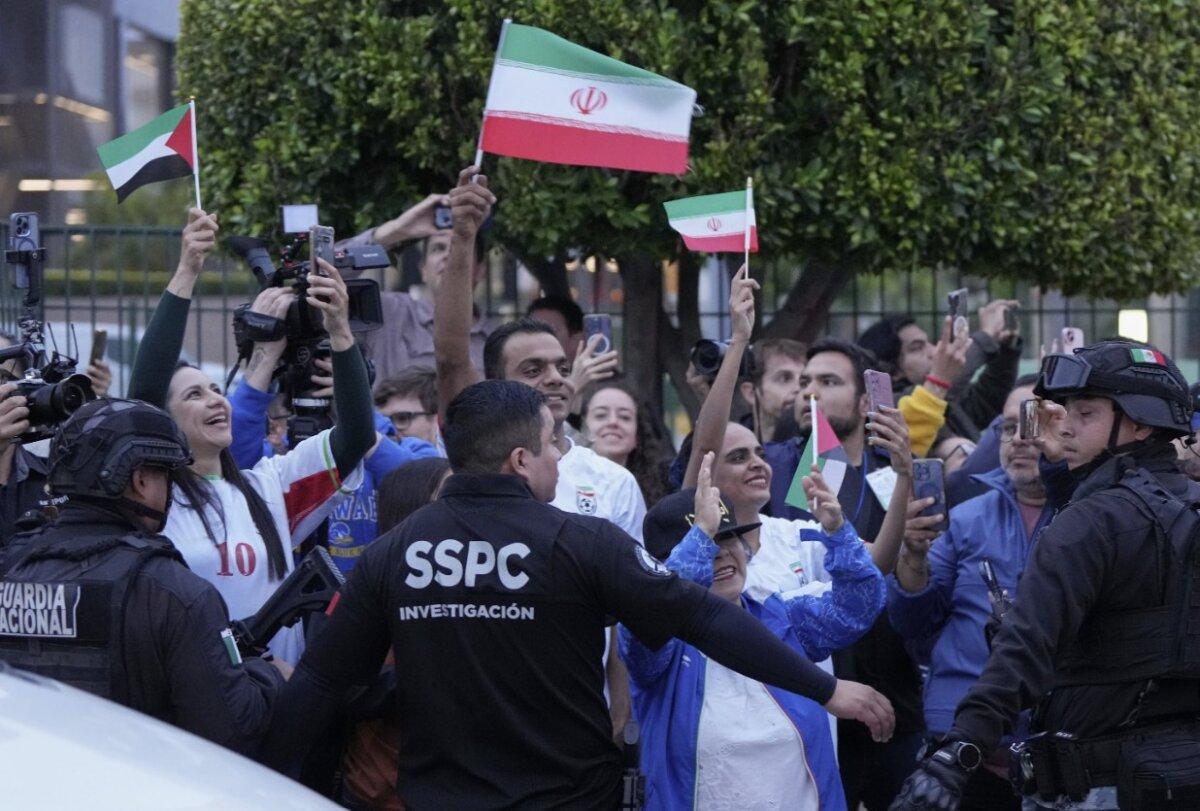 Supporters wave flags as they welcome the Iranian team in Tijuana, Mexico, on June 7, 2026. (Gregory Bull/AP)