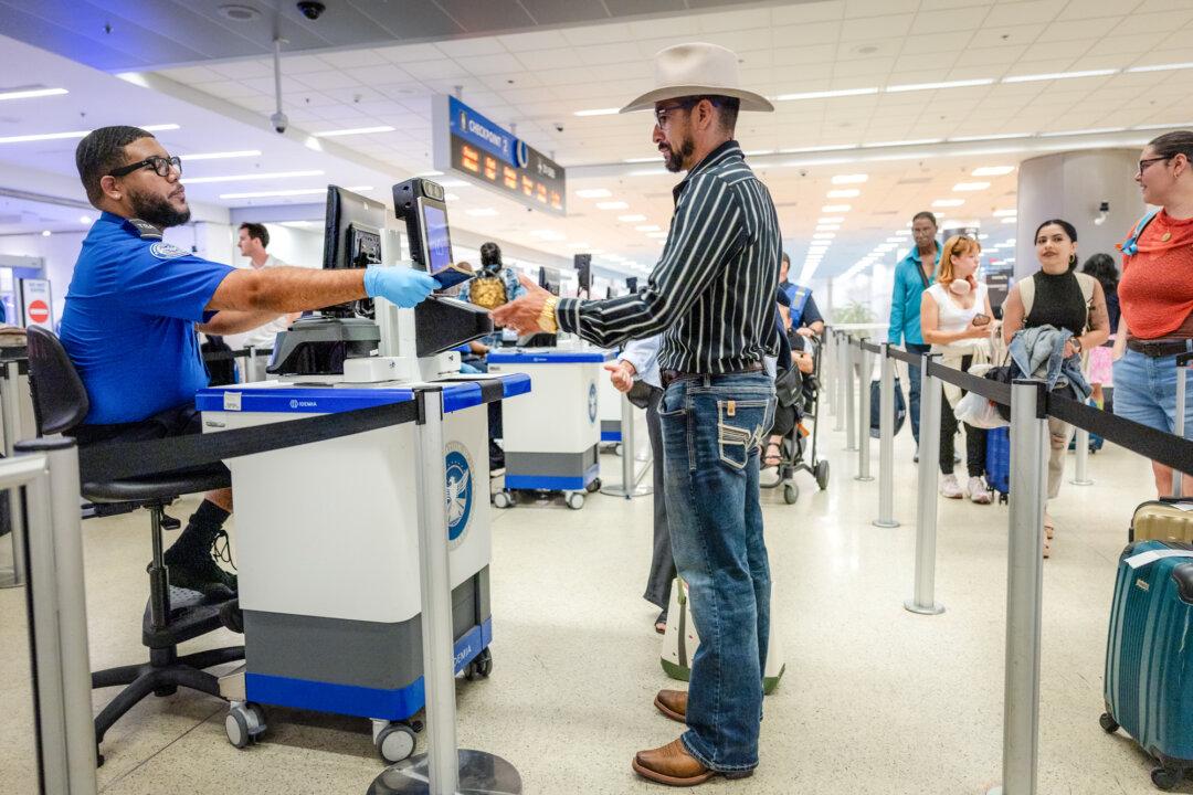 Marvin Suazo, 43, passes through a Transportation Security Administration checkpoint at the Miami airport while self-deporting to Honduras, in Miami on May 25, 2026. Legal experts say a patchwork of conflicting rulings on immigration detention policy has created confusion in the law enforcement community. (John Moore/Getty Images)