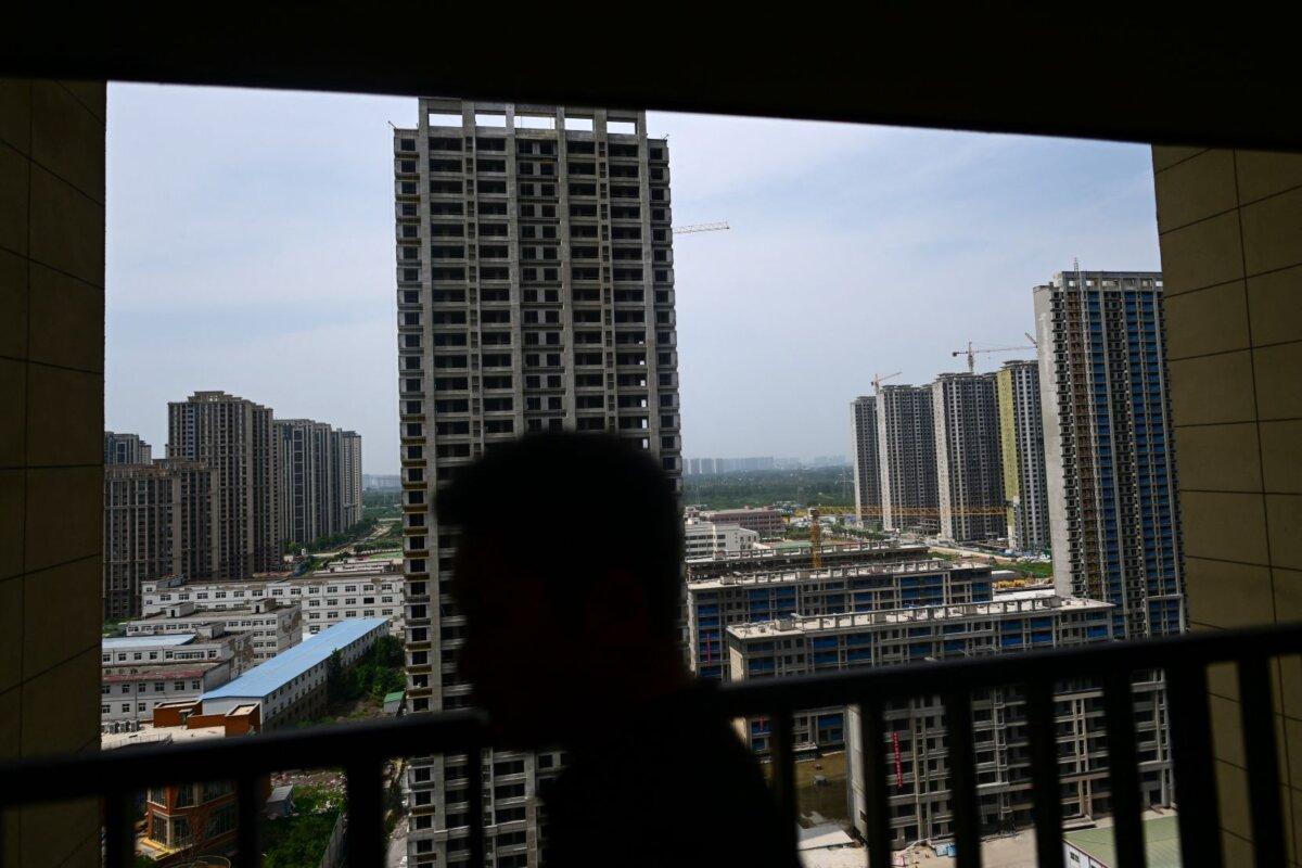 A man showing a flat in a complex of unfinished apartment buildings in Xinzheng City, Zhengzhou, Henan Province, China, on June 20, 2023. (Pedro Pardo/AFP via Getty Images)