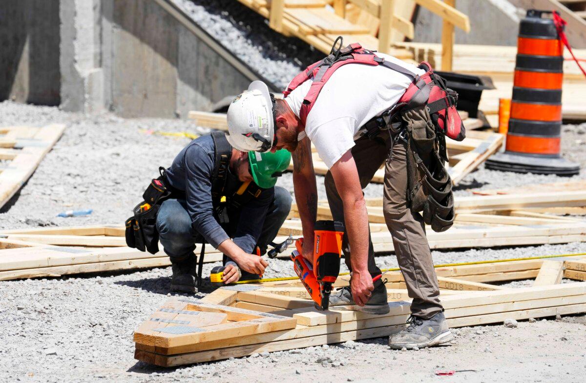 Carpenters build new homes in Ottawa on June 1, 2026. (The Canadian Press/Sean Kilpatrick)