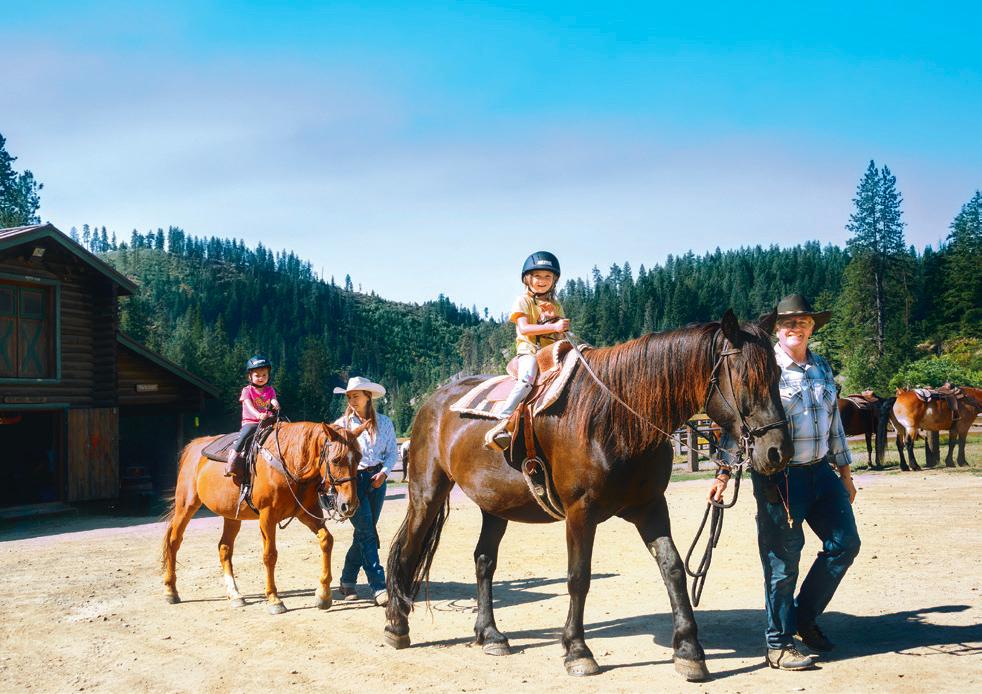 Britton holds a horse’s lead line for children learning to ride. (Maria Coulson)