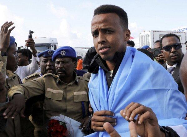 Somali referee Omar Abdulkadir Artan, who had been expected to officiate at matches during the World Cup but was denied entry to the United States, is welcomed as he arrives at the Aden Abdulle Osman International Airport in Mogadishu, Somalia, on June 10, 2026. (Feisal Omar/Reuters)