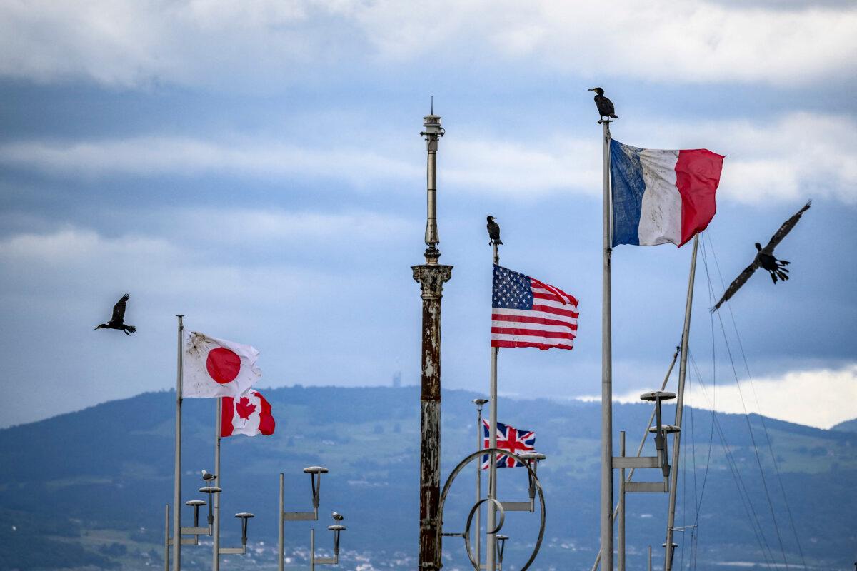 Cormorants fly past the flags of G7 member countries in Evian, France, on June 10, 2026. (Fabrice Coffrini/AFP via Getty Images)