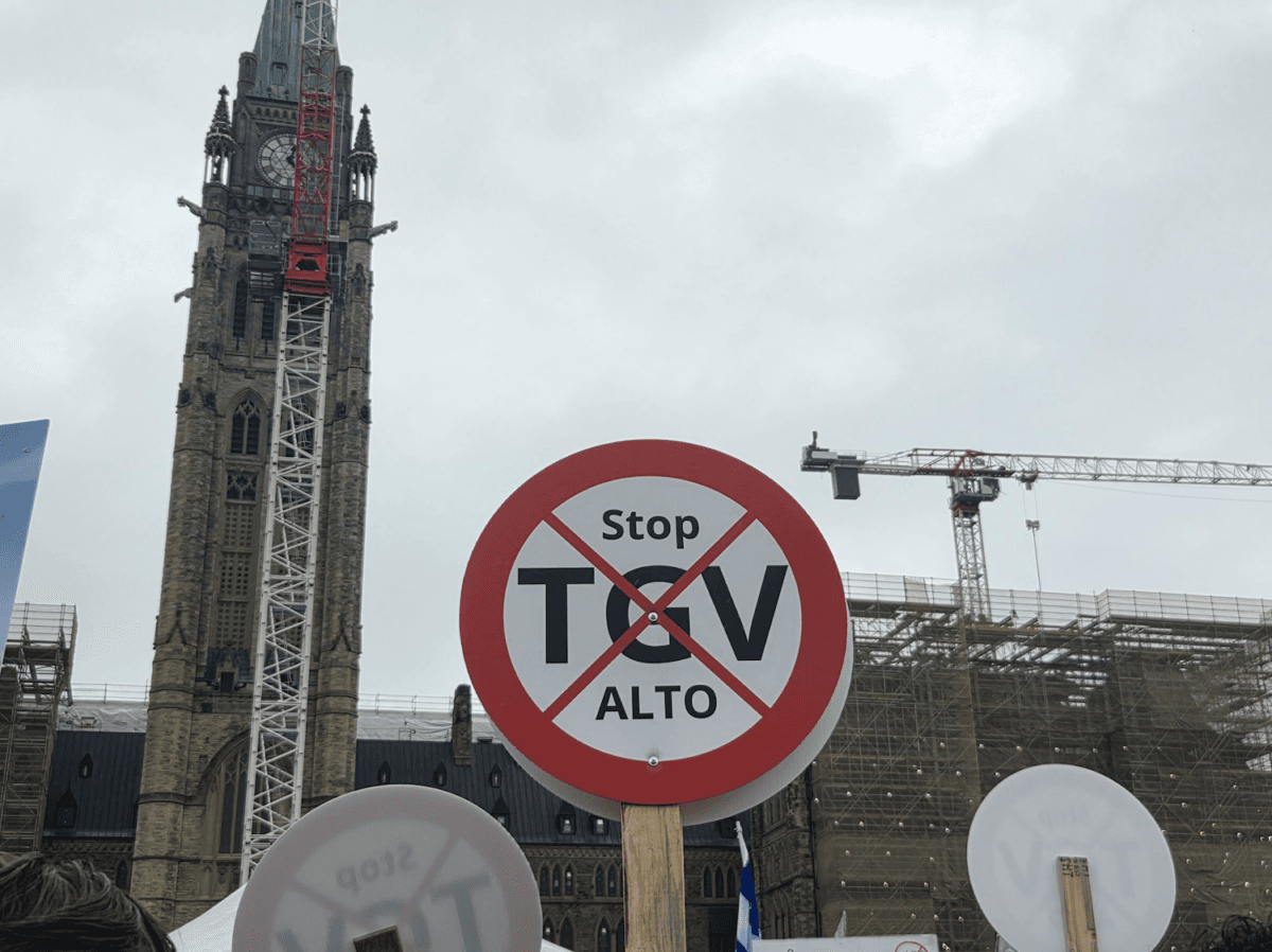 A sign is displayed at the protest against the Alto high-speed rail project on Parliament Hill on June 10, 2026. (Matthew Horwood/The Epoch Times)
