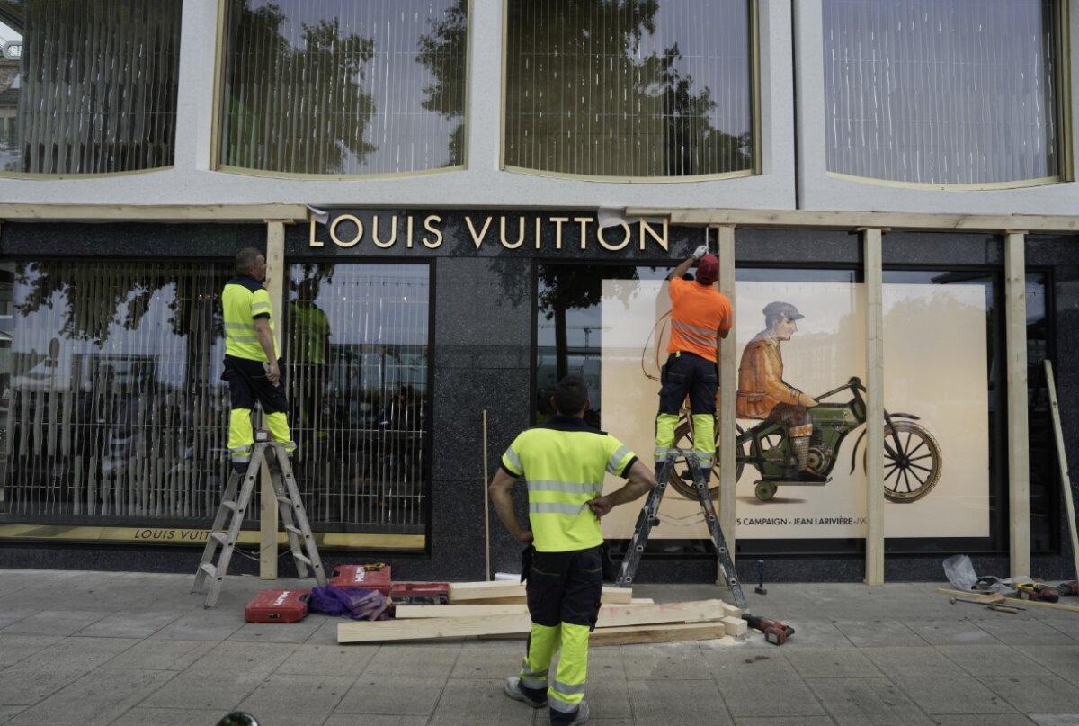 Construction workers board up a shop window ahead of expected protests for the G7 summit, in Geneva, Switzerland, on June 8, 2026. (Baz Ratner/AP)