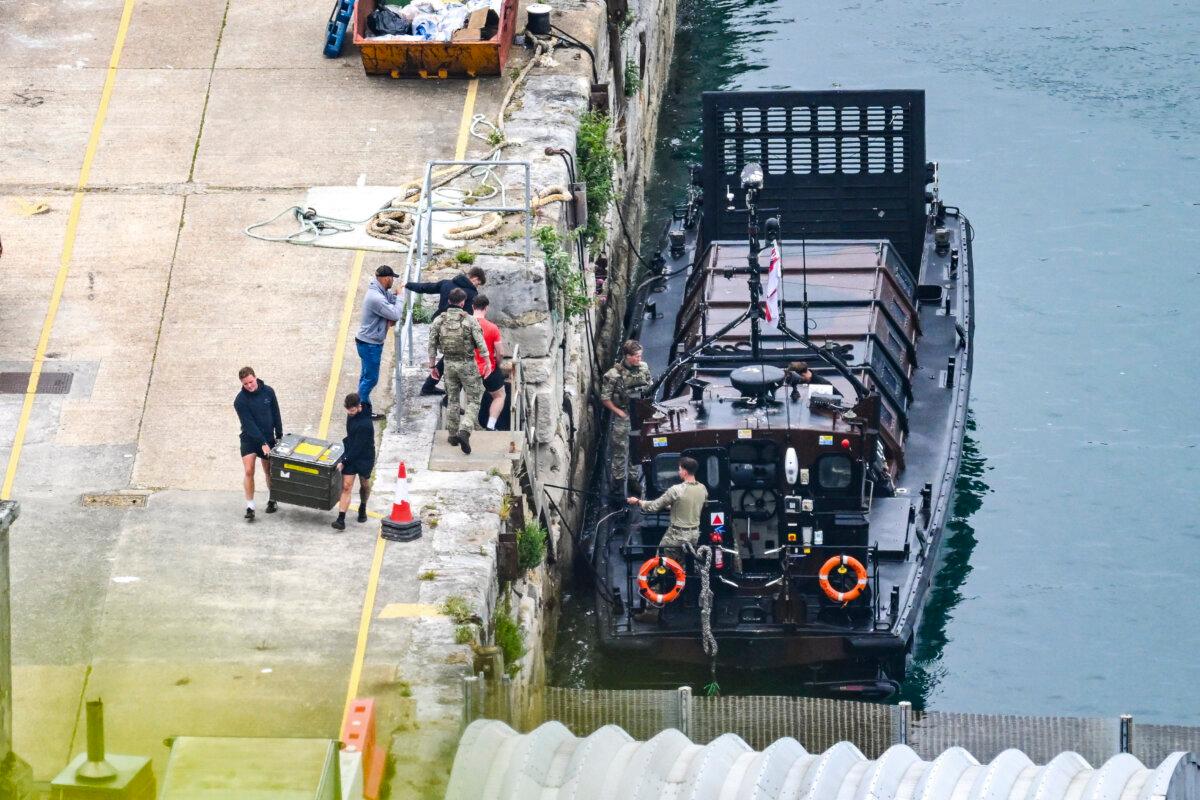 Military personnel return ashore from the detained Smyrtos tanker, in Portland, England, on June 15, 2026. (Finnbarr Webster/Getty Images)