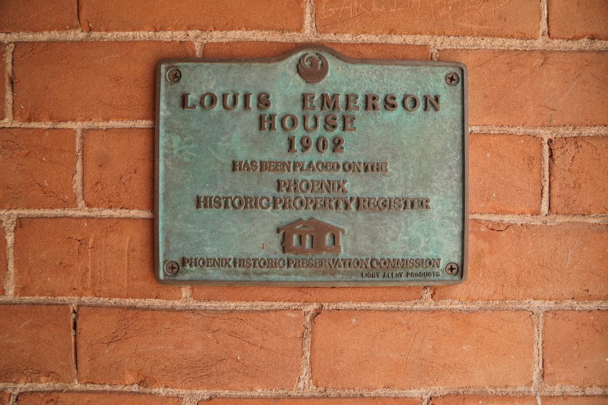 A weathered plaque confirms that the Louis Emerson House is listed on the Phoenix Historic Property Register, on June 13, 2026. (Allan Stein/The Epoch Times)