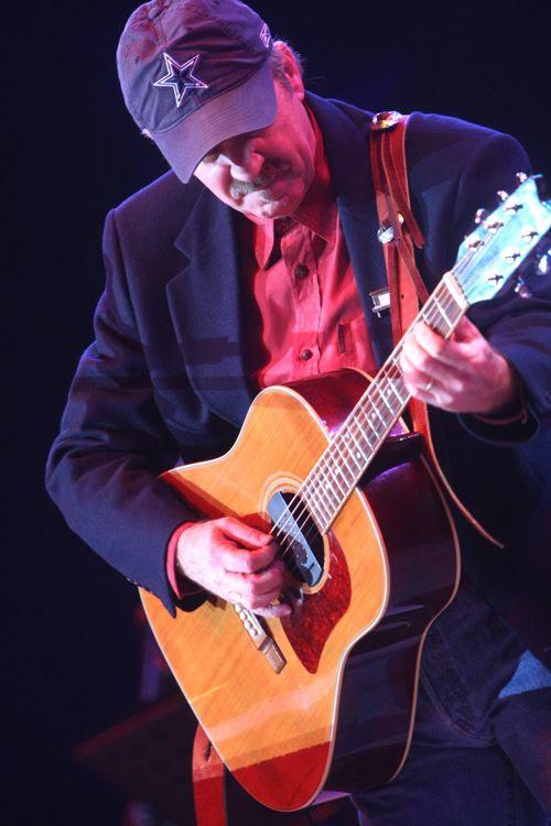 A photograph of musician John Ford Coley playing his six-string guitar. (Courtesy of John Ford Coley)