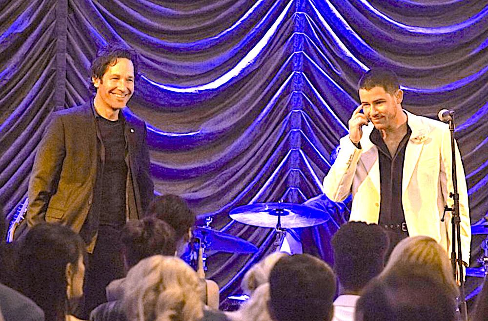 Wannabe rock star Rick Power (Paul Rudd, L) shares the stage with real rock star Danny Wilson (Nick Jonas), in "Power Ballad." (David Cleary/Lionsgate)