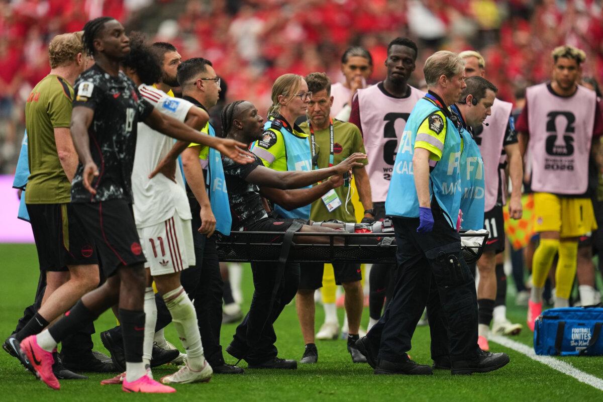 Canada's Ismaël Koné is carried off of the field after receiving medical attention during the World Cup Group B soccer match against Qatar in Vancouver on June 18, 2026. (AP Photo/Abbie Parr)