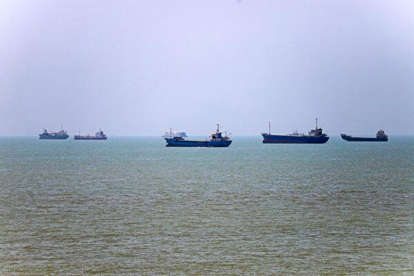 In this picture obtained from Iran's ISNA news agency on June 18, 2026, vessels sit anchored in Bandar Abbas along the Strait of Hormuz. (Amirhossein Khorgooei/ISNA/AFP)