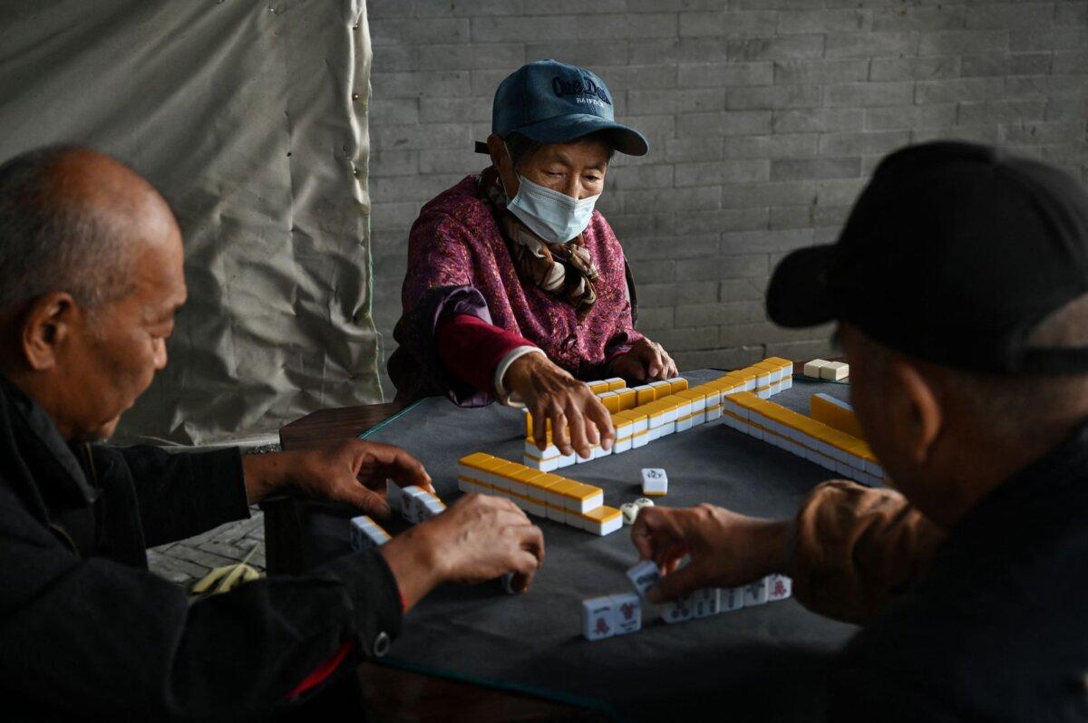 A group of elderly people play mahjong in a small park in Beijing on Nov. 3, 2024. (Greg Baker/AFP)