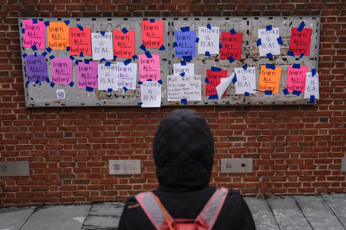 A person views posted signs at the locations of the removed explanatory panels that were part of an exhibit on slavery at the President's House Site in Philadelphia, on Jan. 23, 2026. (Matt Rourke/AP Photo)