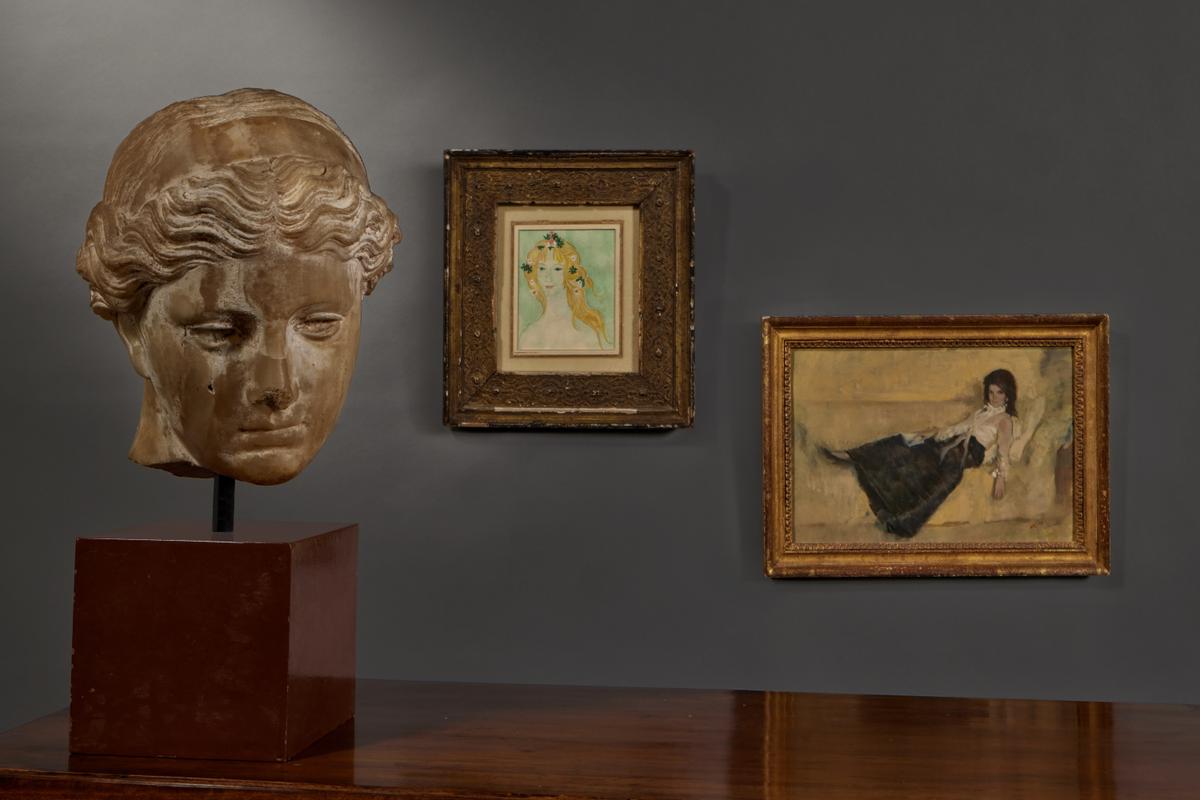 The portrait "Mrs. Onassis on Couch, Book in Lap," 1968, by Aaron Shikler is estimated to auction for $10,000 to $15,000. The exhibition will be on view through June 23, before the auction begins on June 24, 2026. (Sotheby's)