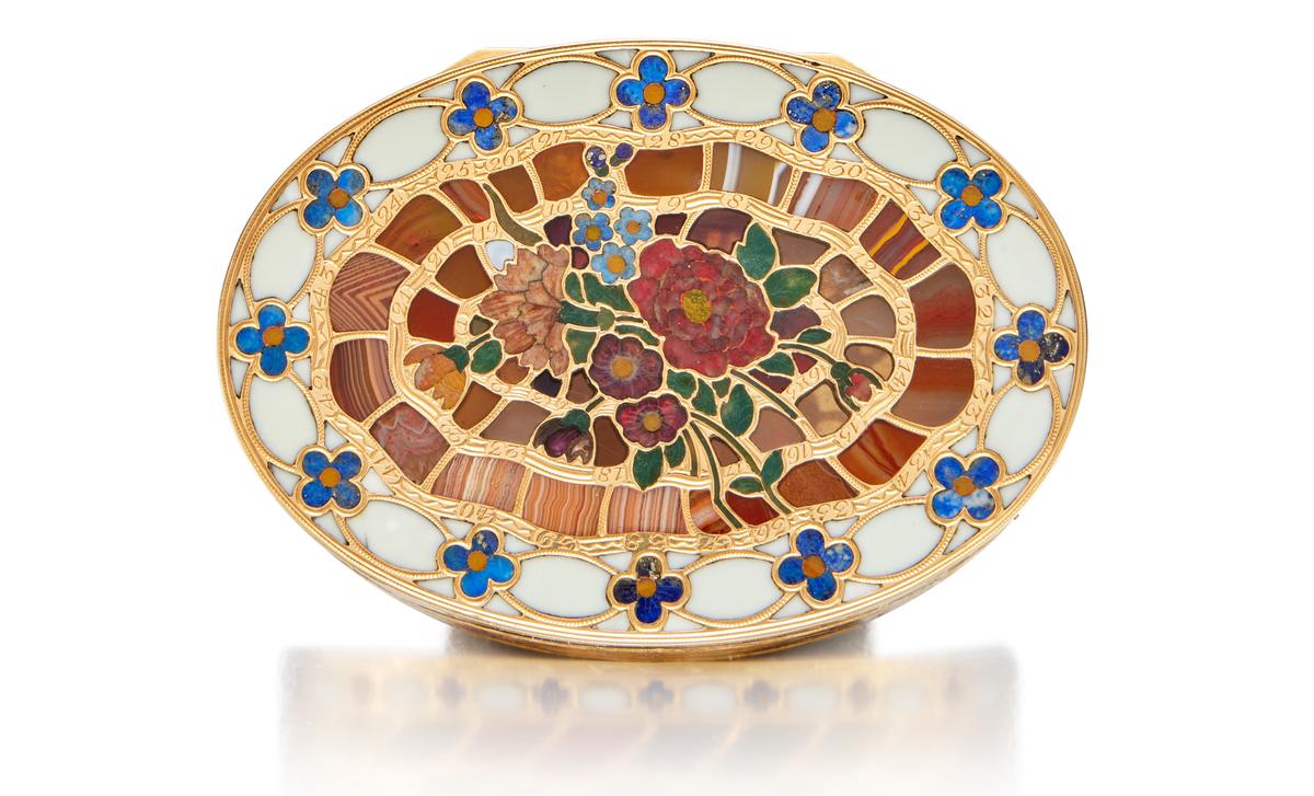 The lid features a peony, a red carnation, tulips, smaller blossoms, and forget-me-nots. (Sotheby's)