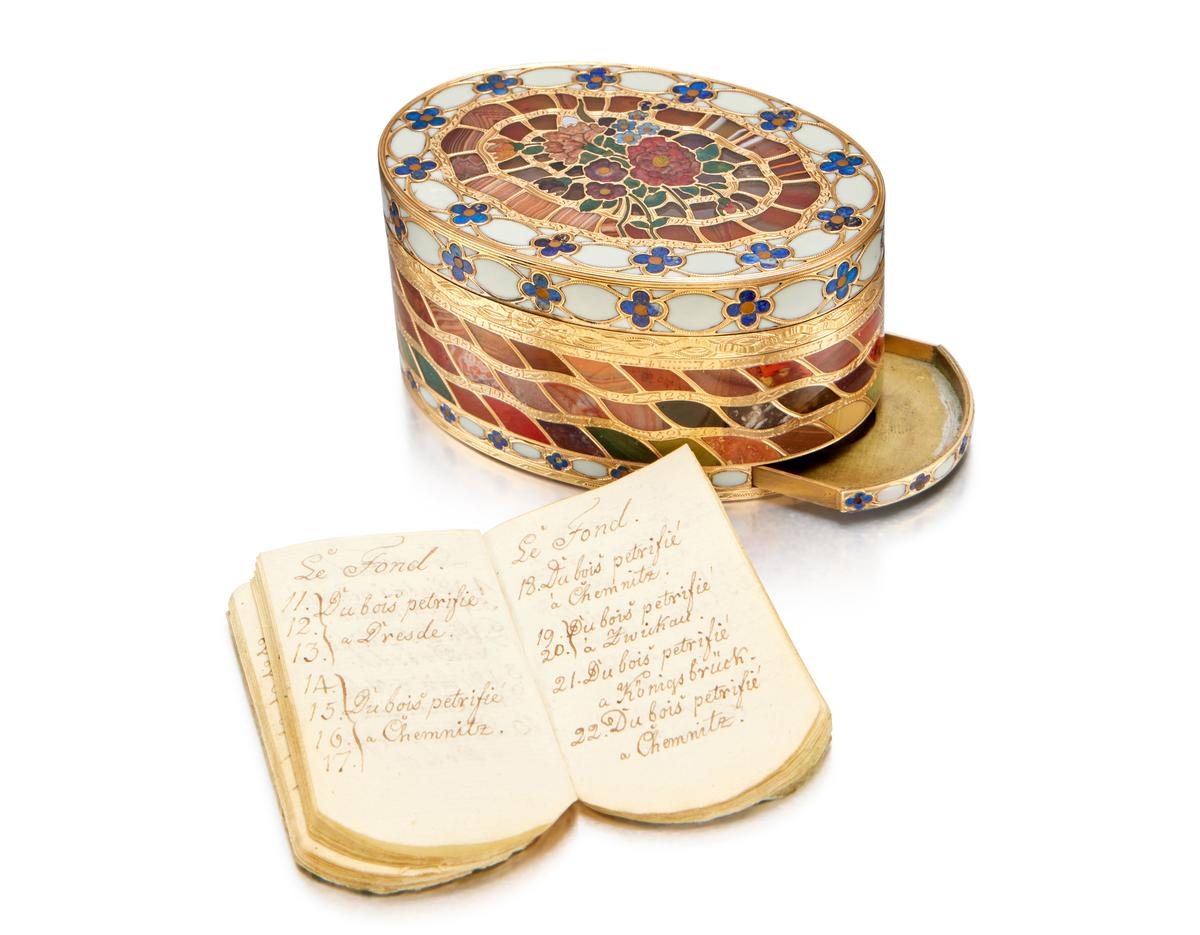 A sliding compartment in the box's base reveals a small handwritten paper booklet that details every hardstone used. (Sotheby's)