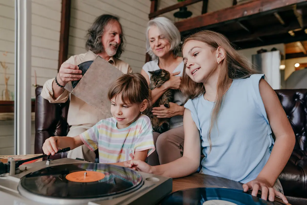 Selecting albums naturally encourages conversation and participation, making it a shared activity. (Westend61/Getty Images)