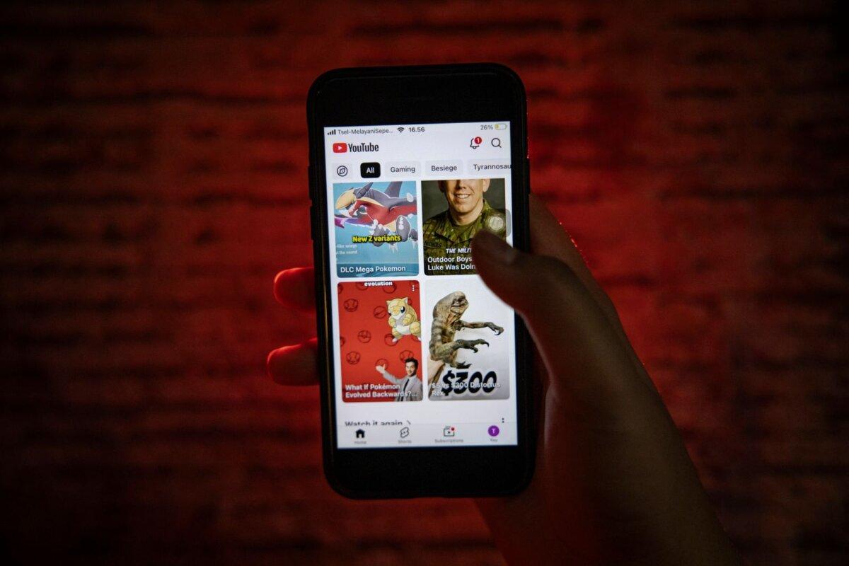 A 12-year-old boy watches YouTube on his smartphone on March 27, 2026. (Ulet Ifansasti/Getty Images)