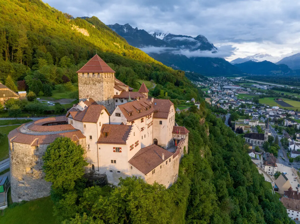 Aerial view of Vaduz Castle, overlooking Vaduz, the capital of Liechtenstein, with the Alps in the background. (Shutterstock/Gideon Ikigai)