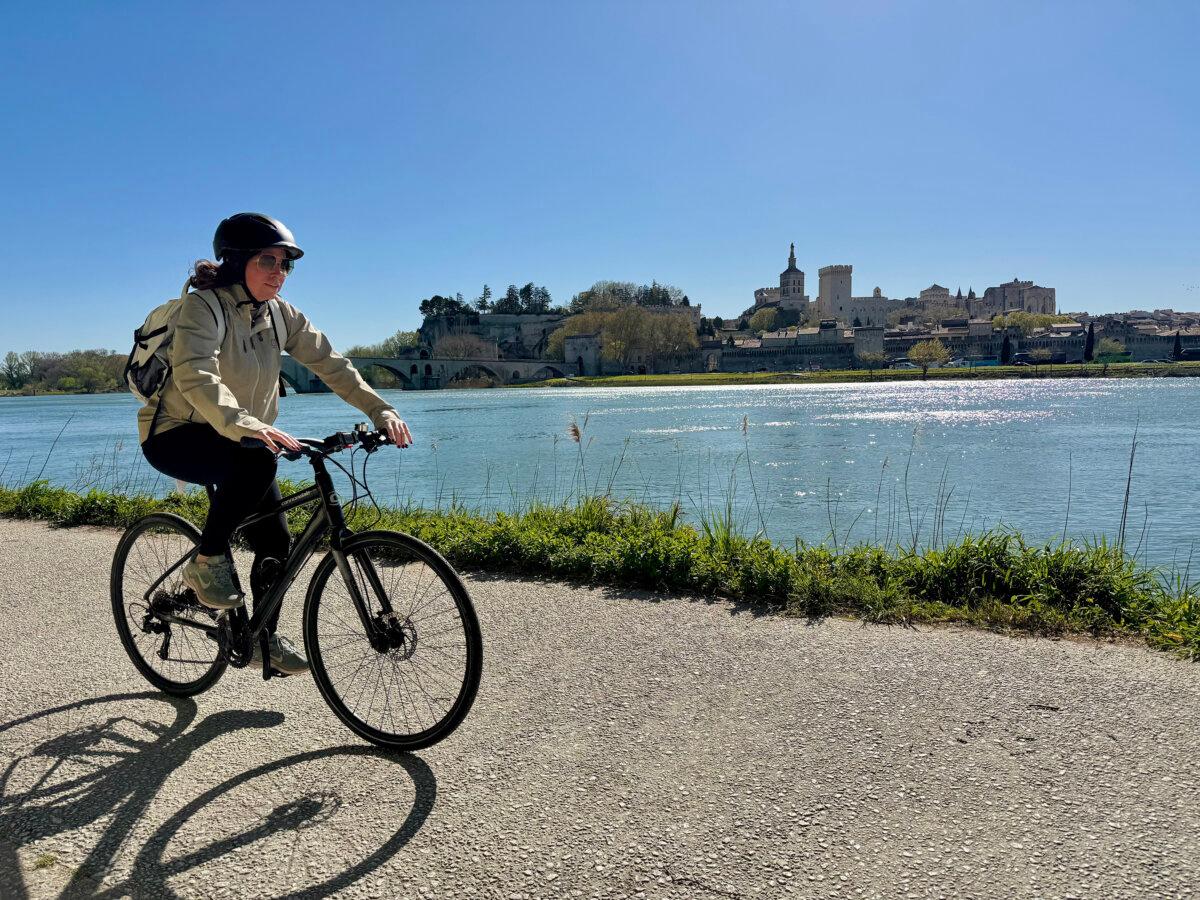 One of the few Lumiere passengers who braved the gusty winds to ride a bike in Avignon. (Lori Rackl/TNS)