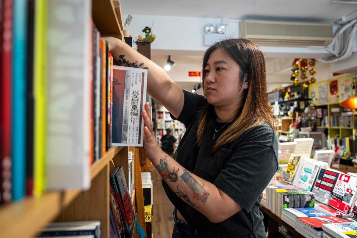 Leticia Wong, a former pro-democracy district councilor, arranges books at her bookstore in Hong Kong on June 20, 2025. (Chan Long Hei/AP Photo)
