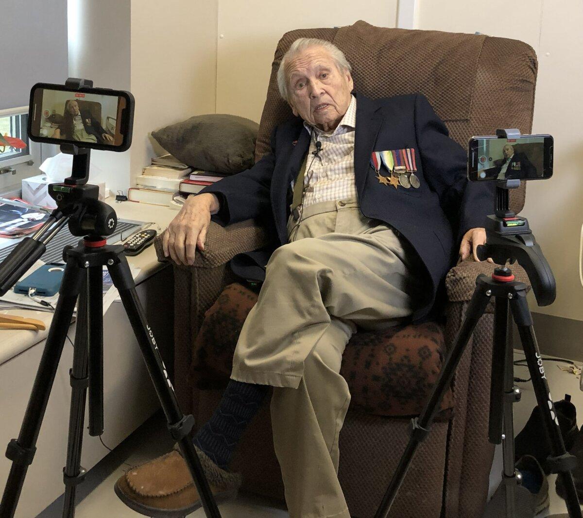 Flanked by two phones recording the conversation, veteran Nick Borisko talks with Zach Dunn about his service during World War II. (Courtesy of Zach Dunn)