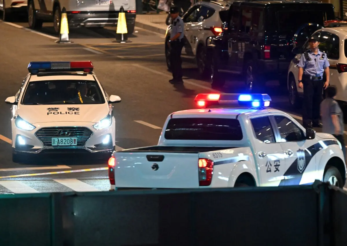 Police personnel block the road near the CITIC Tower in Beijing on June 26, 2026. (Adek Berry/AFP via Getty Images)
