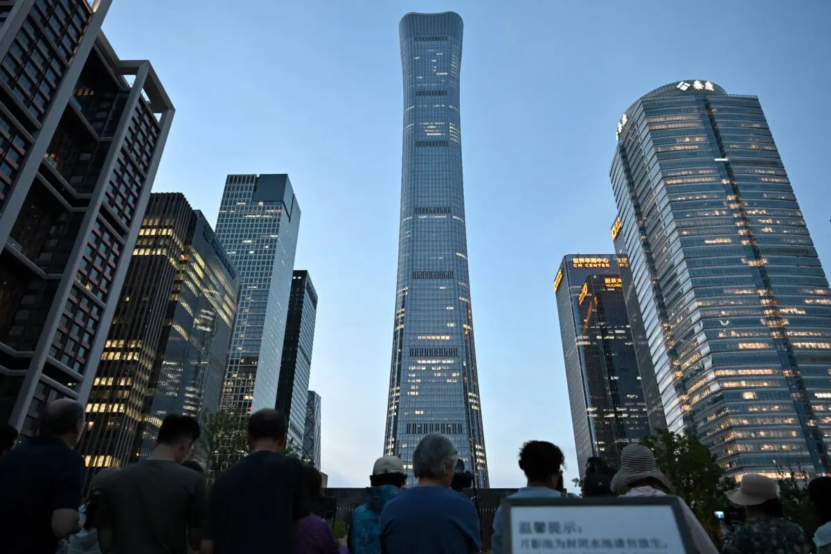 People gather near the CITIC Tower in Beijing on June 26, 2026. (Adek Berry/AFP via Getty Images)