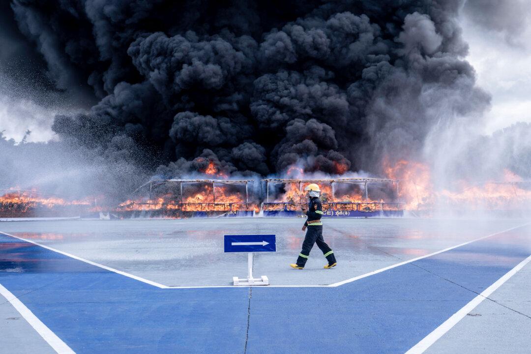 TOPSHOT - A firefighter walks past a burning pile of seized illegal drugs during a destruction ceremony to mark the United Nations' "International Day against Drug Abuse and Illicit Trafficking" in Yangon on June 26, 2026. (Photo by Sai Aung MAIN / AFP via Getty Images)