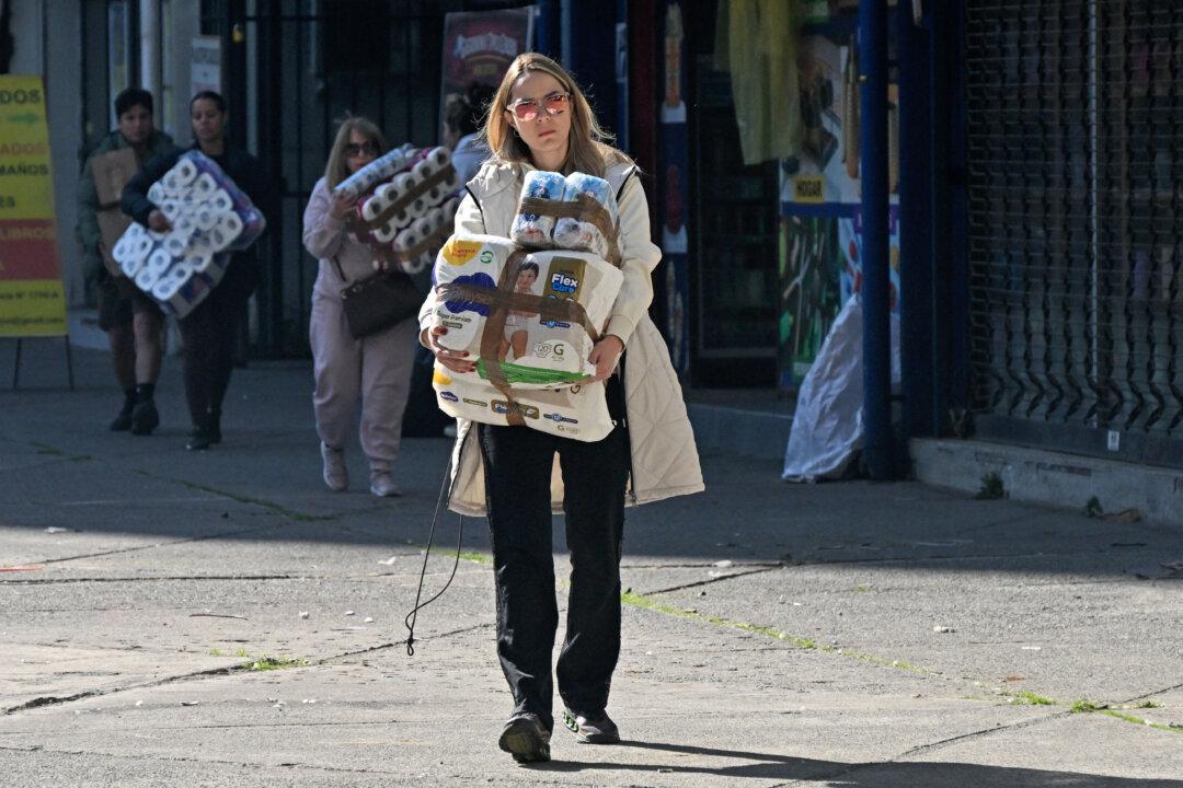 People bring hygiene products to a collection centre as Venezuelans living in Santiago gather supplies to send to their earthquake-stricken homeland, on June 26, 2026, in Santiago, Chile. So far, 589 deaths and more than 50,000 missing people have been reported. after twin earthquakes in Venezuela, as international rescue teams and sniffer dogs arrived to join a desperate search for survivors. (Photo by RODRIGO ARANGUA / AFP via Getty Images)