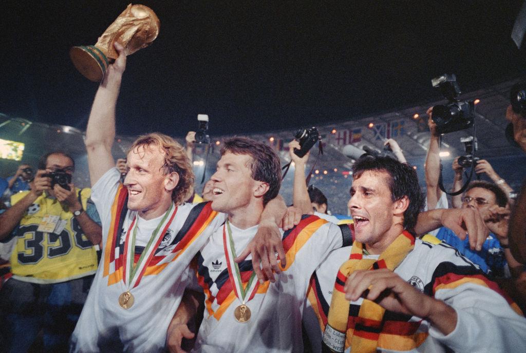 (L–R) West German defender Andreas Brehme, captain Lothar Matthaeus, and Pierre Littbarski celebrate the victory during the World Cup final between West Germany and Argentina on July 8, 1990 in Rome. (Danie Garcia/AFP via Getty Images)