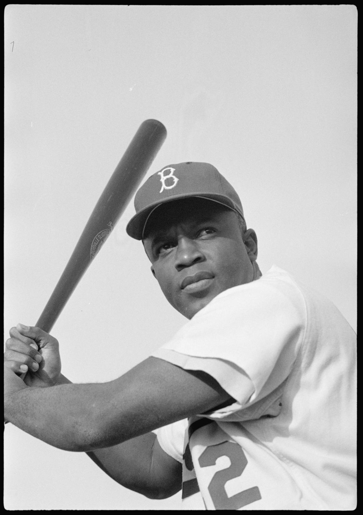A 1954 photograph of Jackie Robinson of the Brooklyn Dodgers, posed and ready to swing. Library of Congress. (Public Domain)