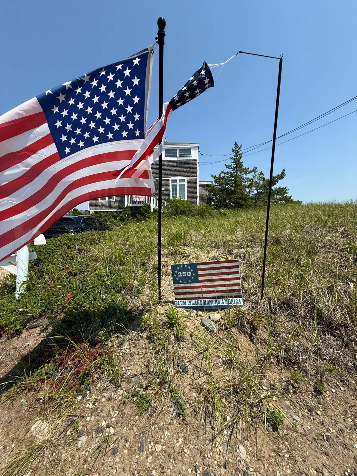 Residents on Plum Island, a village in the town of Newbury, Mass., have taken a stand against a town warning that flags on display violated state environmental regulations. (Mark Sarkady)