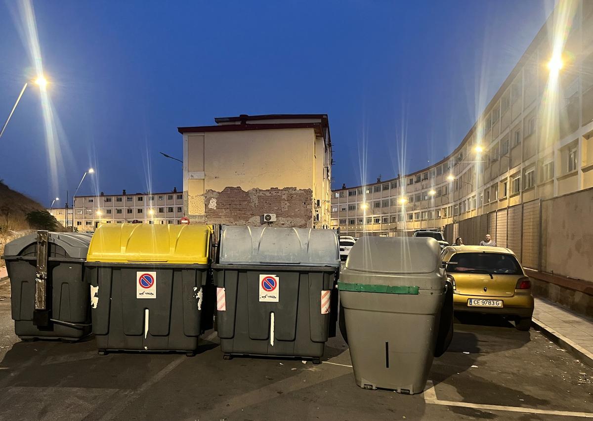 Trash containers are lined up as makeshift barriers on a residential street to restrict access to a residential neighborhood in Ceuta on July 31, 2026. (Etienne Fauchaire/The Epoch Times)