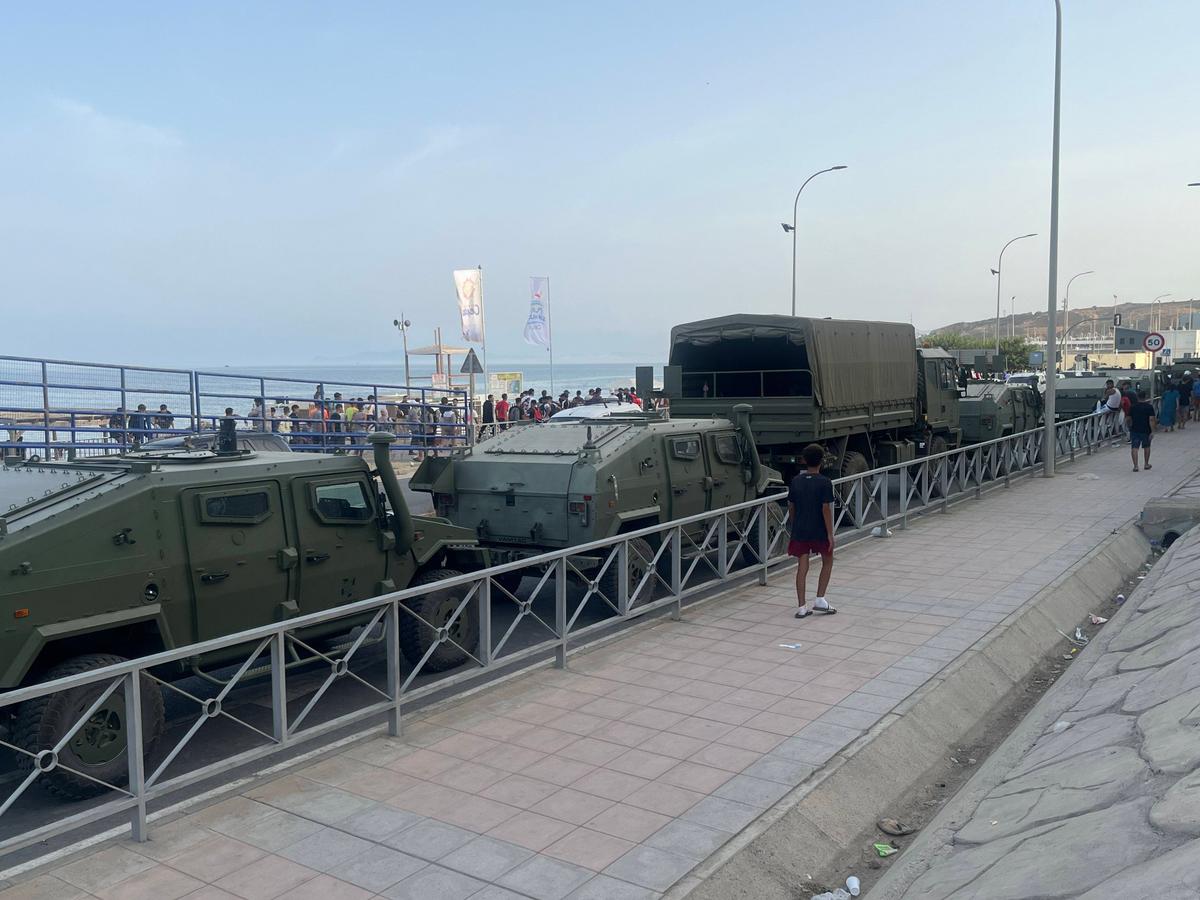 Spanish Army vehicles are positioned along the coastal road near the border as part of the response to the migrant influx in Ceuta, on July 31, 2026. (Etienne Fauchaire/The Epoch Times)