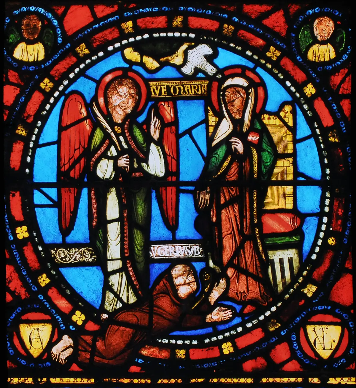 A representation of Abbot Suger prostrating at the feet of the Virgin in the 12th-century stained-glass window in the Basilica of Saint-Denis (Chapel of the Virgin), France. (Public Domain)