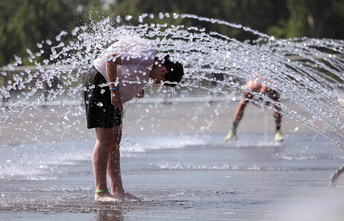 People cool off in a fountain at the Georgetown Waterfront Park in Washington, on July 2, 2026. (Kevin Dietsch/Getty Images)