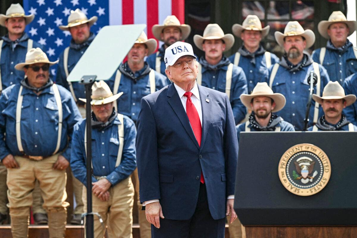 President Donald Trump stands on stage flanked by Rough Riders reenactors, portraying the 1st United States Volunteer Cavalry, at the Burning Hills Amphitheatre after attending the opening of the Theodore Roosevelt Presidential Library in Medora, N.D., on July 1, 2026. (Saul Loeb/AFP via Getty Images)