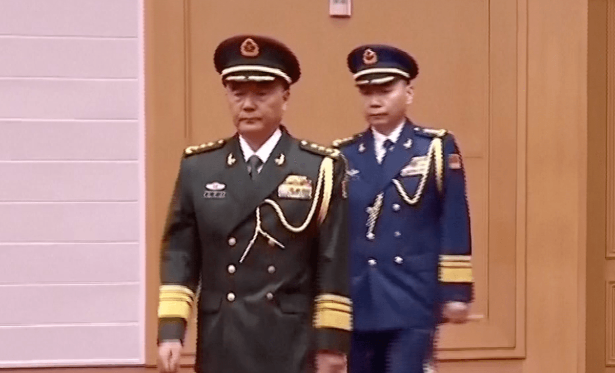 Zhang Shuguang, secretary of the discipline inspection commission, and Wang Gang, commander of the People's Liberation Army Air Force, walk in a general promotion ceremony in Beijing on July 3, 2026. (CCTV via Reuters/Screenshot via The Epoch Times)