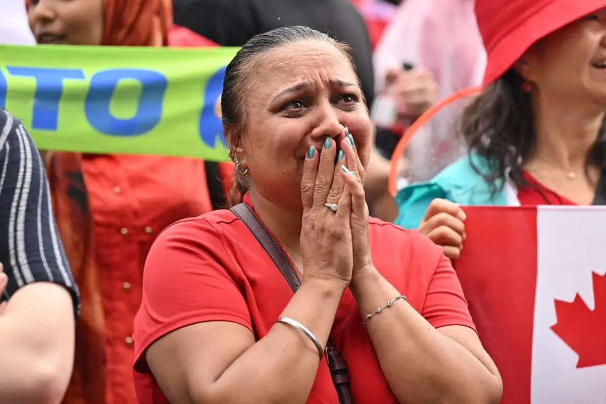 Canadian fans at FIFA Fan Fest react as Morocco defeats Canada to advance during the second half of their World Cup soccer match in Toronto on July 4, 2026. (The Canadian Press/Jon Blacker)