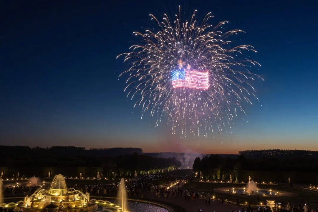 As part of the Night Fountains Show on July 4, 2026, drones illuminated the night sky above the Royal Gardens of Versailles, forming an American flag to mark U.S. Independence Day. (Etienne Fauchaire/The Epoch Times)