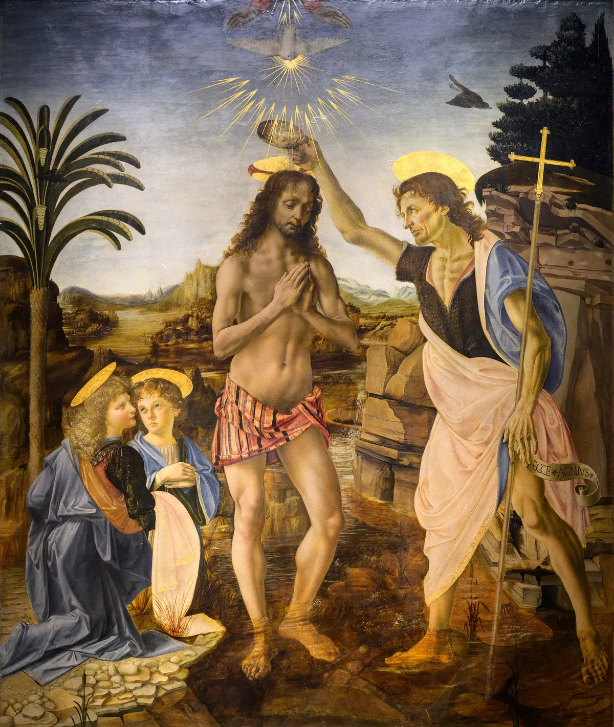 "The Baptism of Christ," 1472–1475, by Verrocchio and Leonardo. Oil and tempera on panel; 70 15/16 inches by 59 7/8 inches. Leonardo's angel is on the far left. Uffizi Galleries, Florence. (<a href="https://commons.wikimedia.org/wiki/File:The_Baptism_of_Christ_(Verrocchio_and_Leonardo).jpg" target="_blank" rel="nofollow noopener">Justin Benttinen</a>/<a title="Category:CC-BY-SA-4.0" href="https://commons.wikimedia.org/wiki/Category:CC-BY-SA-4.0">CC-BY-SA-4.0</a>
