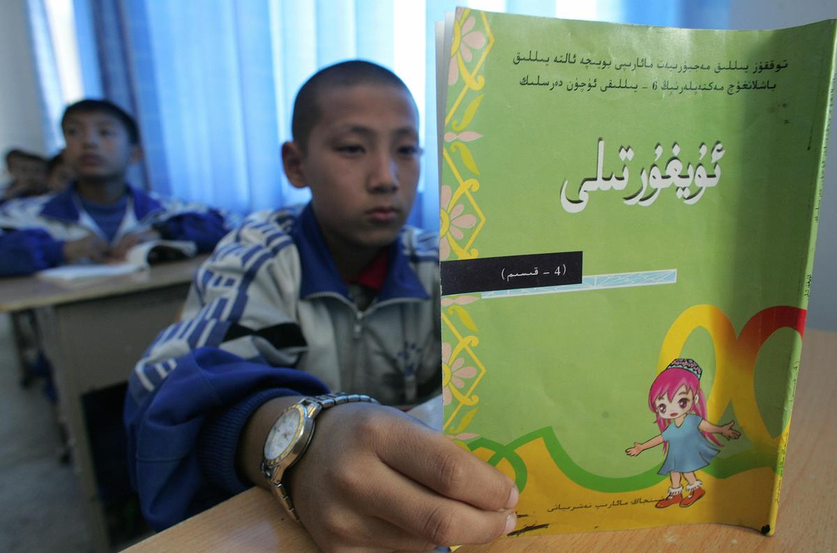 A student reads his lessons in a classroom at a bilingual middle school for ethnic-Uyghur Muslim and Han Chinese students in Hotan, Xinjiang, on Oct. 13 2006. (Frederic J. Brown/AFP via Getty Images)