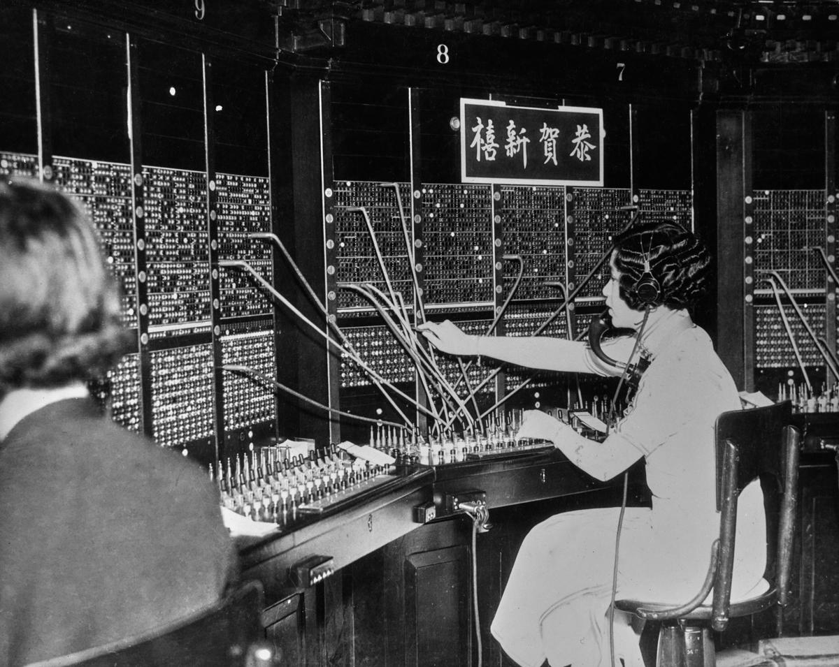 A switchboard operator connects a call at the telephone exchange in Chinatown, San Francisco, 1913. (FPG/Getty Images)