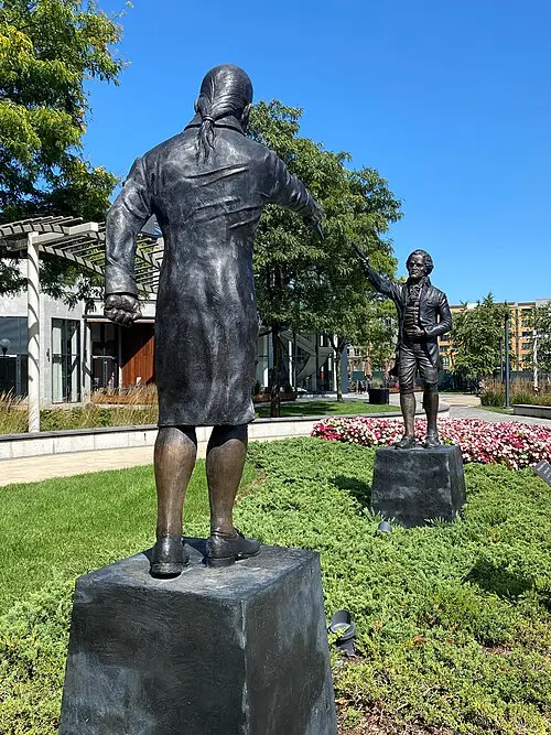 A dramatic artistic rendering of the moment shots were fired on the cliffs of Weehawken, N.J., resulting in the mortal wounding of Alexander Hamilton. (Rich Romano/<a href="https://commons.wikimedia.org/wiki/File:Hamilton-Burr_Duel_Monument.jpg">CC BY-SA 4.0</a>)