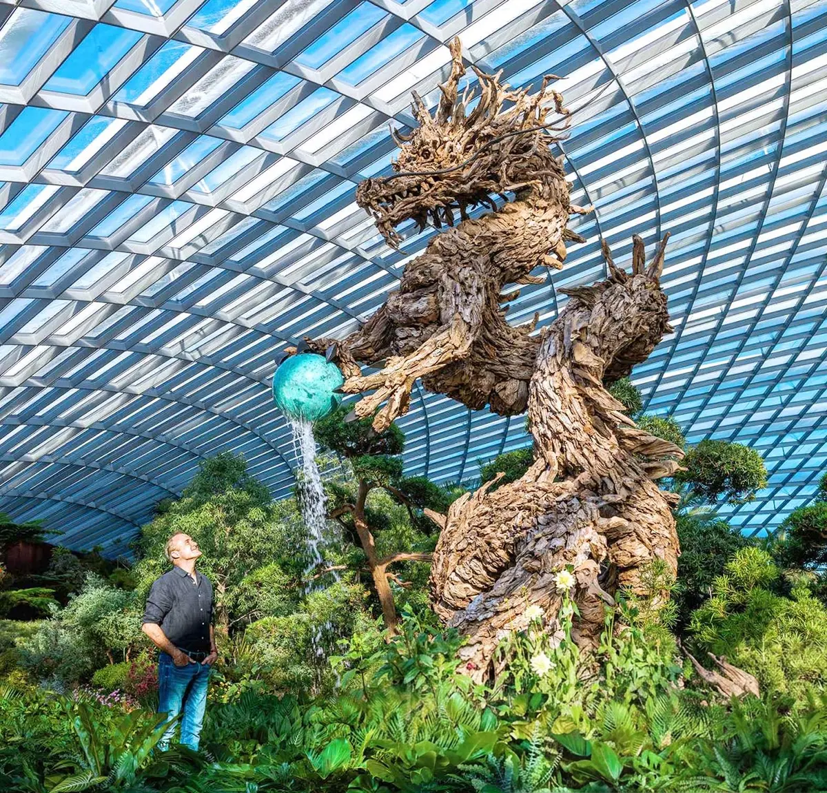 James Doran-Webb looks up at his towering 7,000-pound driftwood dragon. (Courtesy of James Doran-Webb)